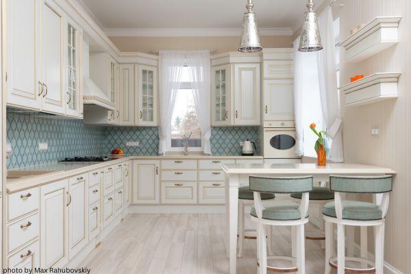 silver pendant light in white and gold kitchen