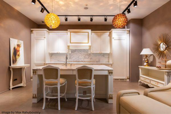 gold hanging chandelier in white and gold kitchen