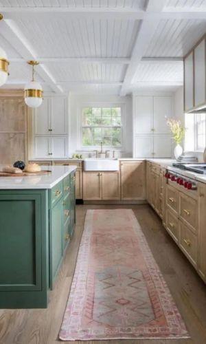 installing wood flooring in sage green kitchen