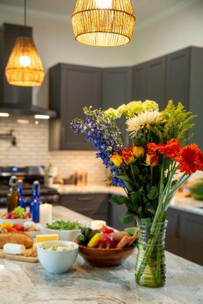 A beautiful bouquet of flowers arranged on a kitchen island